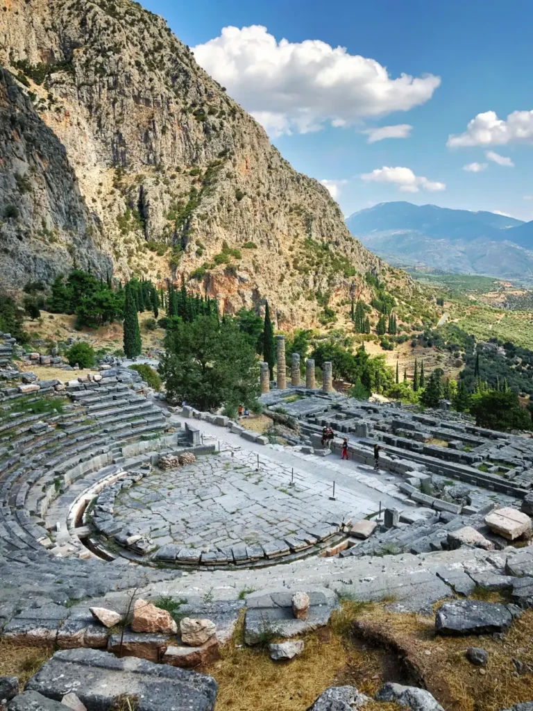 Ancient theatre in Delphi with panoramic view of mountains and archaeological site.